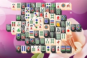 En bild av en bräda med mahjongbrickor i olika mönster och symboler mot en rosa bakgrund med blommotiv