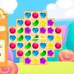 Ett färgglatt pusselspel med symboler som hjärtan och stjärnor på en spelfält, omgiven av en lekfull bakgrund och spelstatistik till vänster