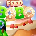 Tecknad grön karaktär med stora ögon, omgiven av kakor och en stor tårta i bakgrunden, med texten Feed Bobo