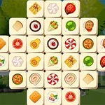 Kakel med olika matbilder som kex, godis och frukt, arrangerade i ett rutnät mot en utomhusbakgrund
